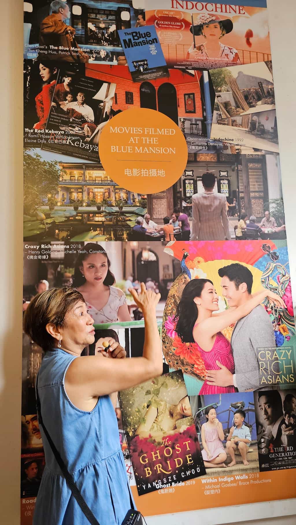 A display inside the Blue Mansion showing film posters and stills from movies shot there, including Crazy Rich Asians