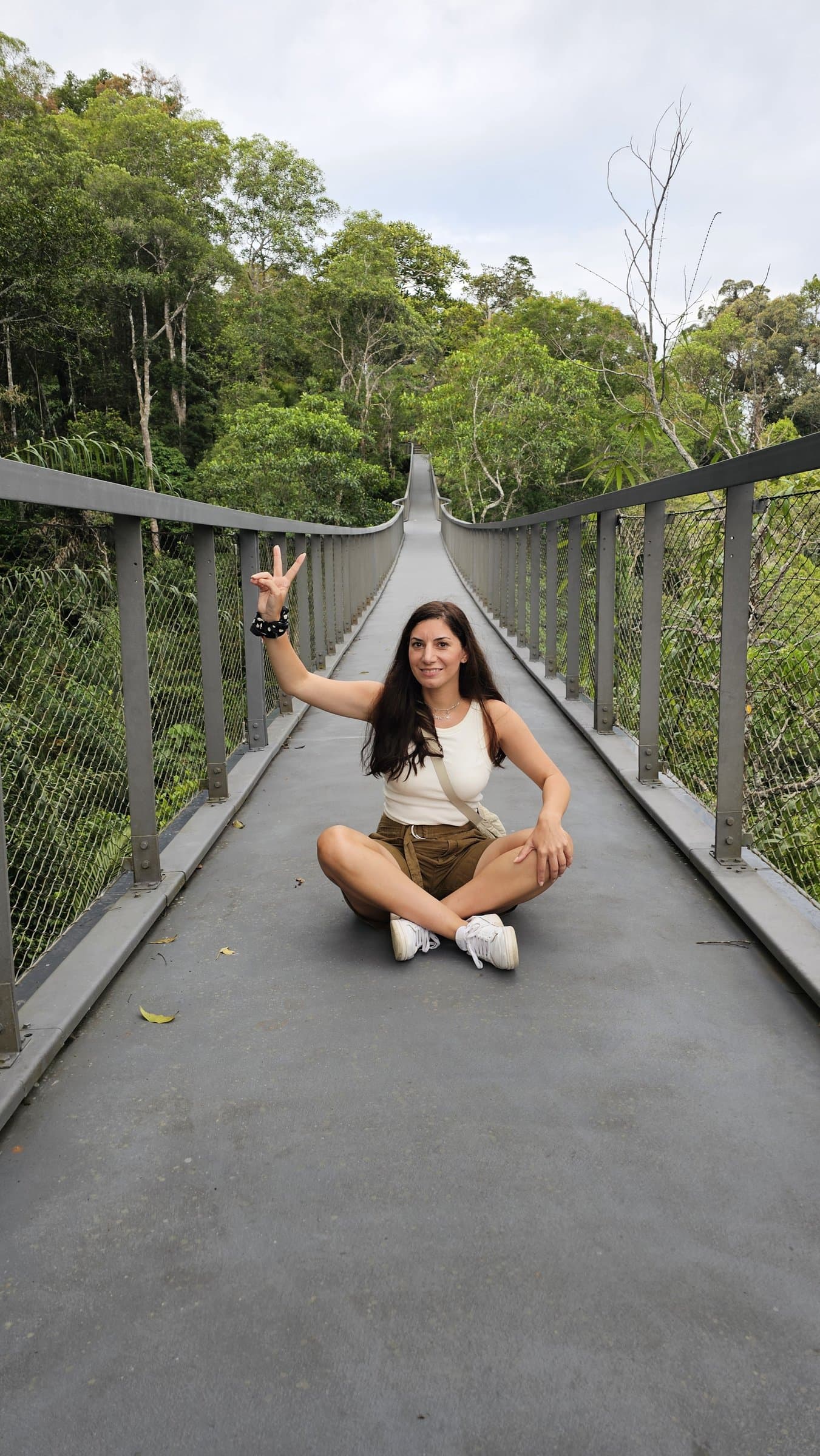A visitor on the elevated canopy walkway through the rainforest at The Habitat Penang Hill