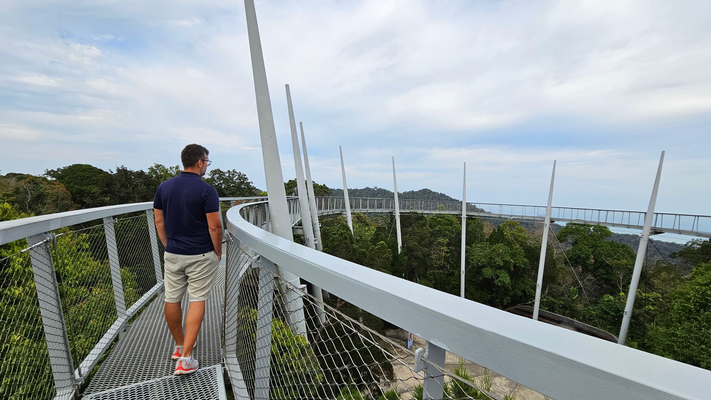 Walking the curved canopy walkway at The Habitat, high above the rainforest on Penang Hill