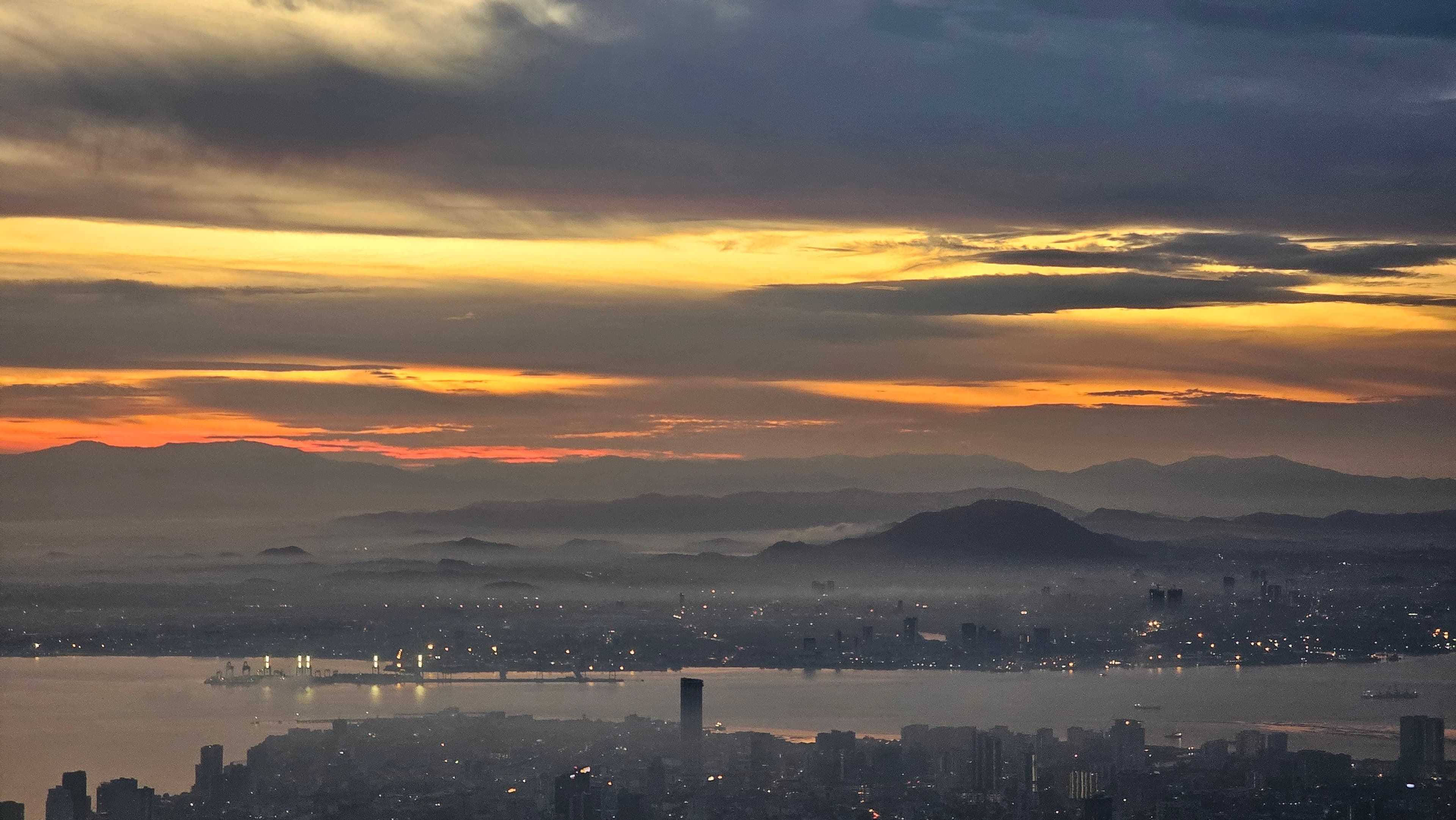 Sunset over George Town, the strait, and the mainland hills, seen from the top of Penang Hill